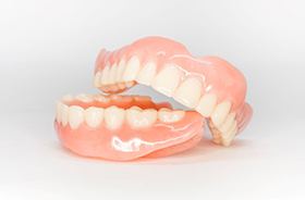 Full dentures against neutral background