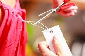 Using scissors, not teeth, to remove tag from clothing