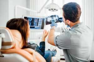 Dentist and patient reviewing X-rays together